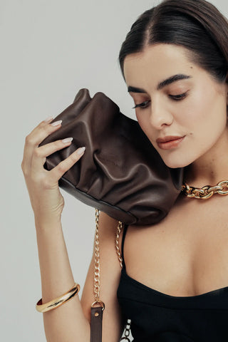 Modelo con el bolso Mini Carmen chocolate en mano en estudio. Valentina Rivera Madrid.